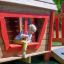 a boy playing in the playhouse