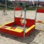 Playground equipment Jupiter in red and yellow on the sand.
