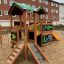 Jungle House playhouse with slide in a playground.