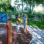 Man playing on Race Track Board in outdoor playground.