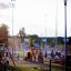Children playing on a Country House playhouse with slide at a playground.