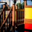 Country House playhouse with slide in a playground setting.