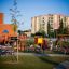 Country House playhouse with slide in a colorful playground setting
