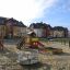 Country House playhouse with slide in a playground