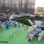 Winter Mansion playground equipment with slides, swings, and climbing structures on a green play are