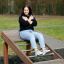 Woman exercising on Roman bench for back muscles outdoors.