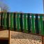 Jungle City castle with slide featuring a wooden bridge with green and black panels.