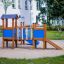 a playground with a tower and a slide for kindergartens