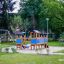 an outdoor playground with a tower and a slide