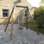Sandbox with Baby Single Swing in residential outdoor area.