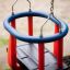 Baby Single Swing with red and blue seats hanging on chains.