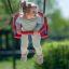 A child enjoying a ride on a Double Baby Swing in a park.