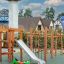 Green Grasshopper Spring Rider playground equipment on safety surface by wooden climbing structure w