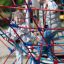 Children climbing on Autan playground climbing net in outdoor park