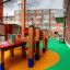 Outdoor playground with colorful Wetpour 45 rubber flooring and wooden play structures.