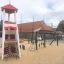 Lighthouse single playhouse with climbing net in playground