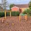 Obstacle course in a playground with climbing frames and balance beams.