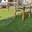 Obstacle course for children on playground with climbing nets and wooden structures