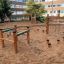 Outdoor wooden obstacle course with climbing nets for kids.