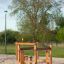 Trim trail wooden playground climbing structure on sandy surface in park