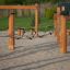 Trim trail wooden playground climbing rope bridge on sandy ground