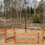 Outdoor Trim trail wooden adventure course surrounded by forest.
