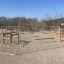 Outdoor Trim trail playground equipment in a sandy area.