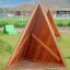 Tipi Nature wooden playhouse on children's playground