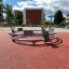 Bicycle merry-go-round on playground with rubber surface