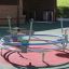 Bicycle merry-go-round playground equipment with four seats and handlebars