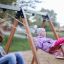 Children enjoying the 2+2 multiple swing in a playground.