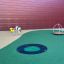 Bee w/ Wooden Deck' playground equipment with a spring ride bee figure and circular wooden deck.