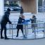 Wheelchair Accessible Merry-go-round with two children and adult in urban playground