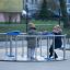 Wheelchair Accessible Merry-go-round with seats and handles on a playground.