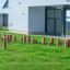 Outdoor play area with Cape Code âŚ€ 20-25 cm wooden posts set up on the grass.