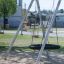 a galvanized steel swing with a bird nest seat