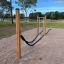Outdoor Battle Rope Workout Set with wooden posts in a park.