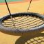 Bird Nest Single Swing (BNS 120 cm) on a playground.