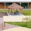 Obstacle Course Crawl Net hanging between wooden posts on playground.
