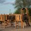 Wooden Challenger Modern Nature playground structure with slide and climbing elements on sandy groun
