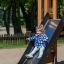 Child sliding down Zebra Modern Nature single slide in playground.