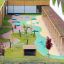 Picnic Shelter w/ Blackboard playground seating area with chalkboards on green playground surface.