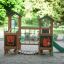 Forest Treehouse wooden playground with slide and animal illustrations in a sandy park area