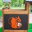 Forest Treehouse playground wooden panel with orange squirrel design