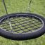 Bird Nest Single Swing 2 Posts (Metal) with black net seat hanging outdoors.