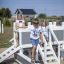 a white ship sandpit with children playing