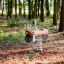 Spring rocker for children in the shape of a bike in a forest playground.