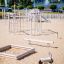 a white spring rider made of robinia wood on the beach playground