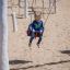 a girl swinging on the cradle seat swing