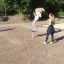 Child playing on Spinner I playground equipment outdoors.